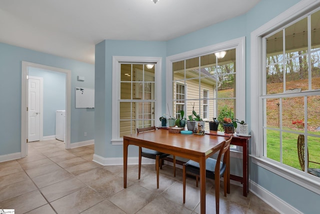 dining area with light tile patterned floors, baseboards, and washer / dryer