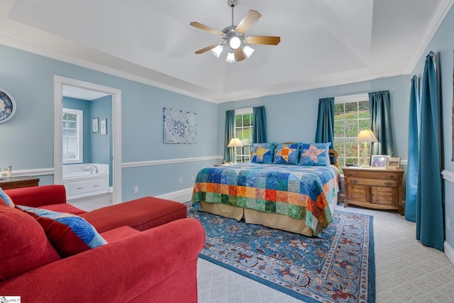 bedroom featuring a tray ceiling, a ceiling fan, ornamental molding, and carpet floors