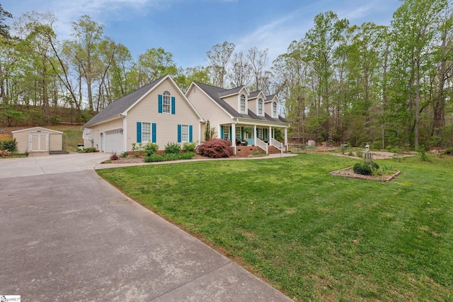 cape cod-style house featuring a porch, a garage, a storage unit, a front lawn, and driveway