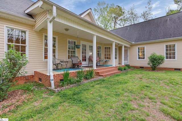 rear view of house featuring a yard, crawl space, and roof with shingles
