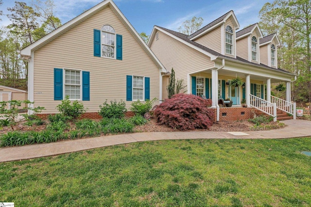 view of front of home with covered porch and a front yard