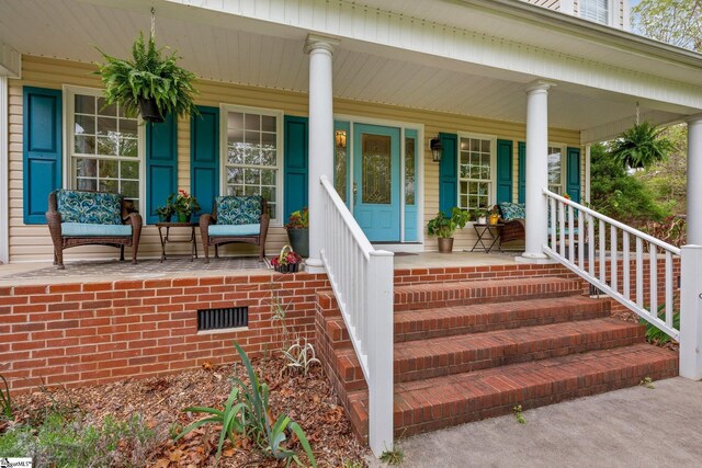 entrance to property featuring a porch