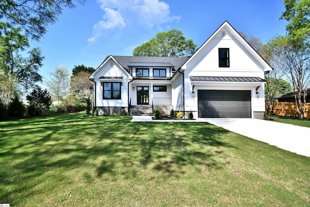 modern farmhouse with fence, a front lawn, french doors, a garage, and driveway