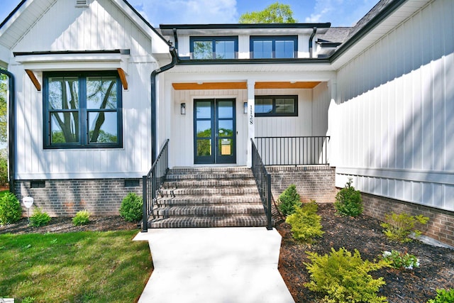 doorway to property featuring crawl space, french doors, and covered porch