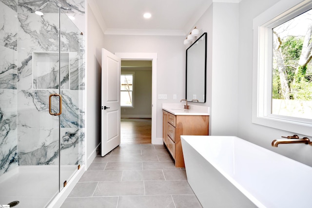 bathroom featuring vanity, baseboards, ornamental molding, a soaking tub, and a marble finish shower