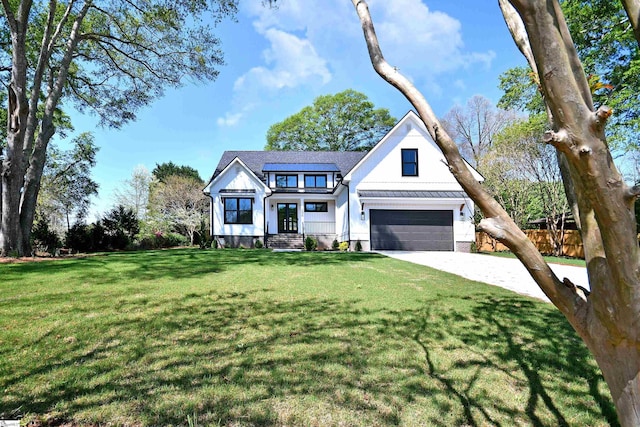 view of front of house featuring a front yard, fence, an attached garage, french doors, and driveway