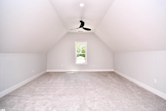 additional living space featuring ceiling fan, visible vents, vaulted ceiling, carpet flooring, and baseboards