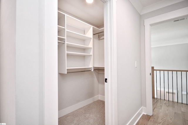 spacious closet with wood finished floors and visible vents