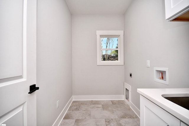 washroom with electric dryer hookup, baseboards, hookup for a washing machine, and cabinet space