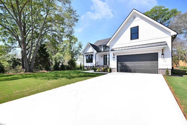 modern farmhouse style home featuring a front yard, board and batten siding, a garage, and concrete driveway