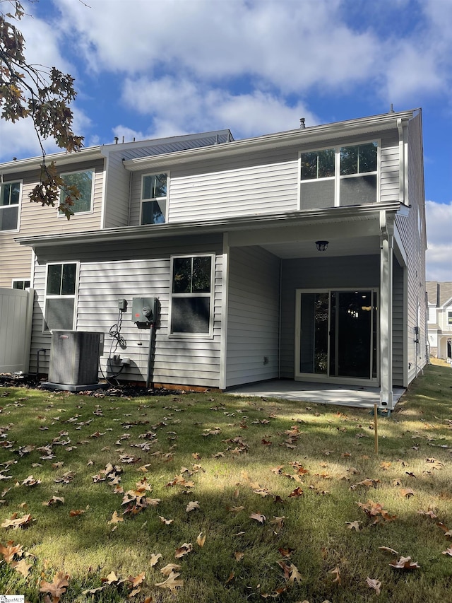 back of house with a patio, a lawn, and central air condition unit