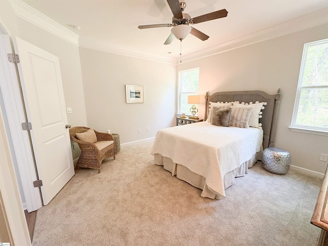 bedroom featuring light carpet, ceiling fan, baseboards, and ornamental molding