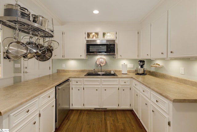 kitchen with stainless steel appliances, light countertops, white cabinetry, and a sink
