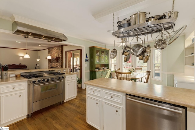 kitchen featuring ornamental molding, light countertops, white cabinets, dark wood finished floors, and appliances with stainless steel finishes