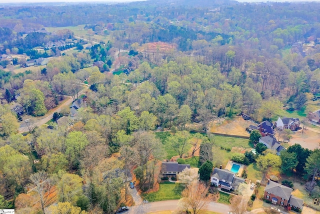 aerial view featuring a wooded view