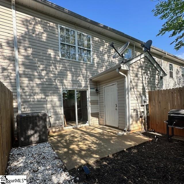 rear view of property featuring central air condition unit, a patio, and fence