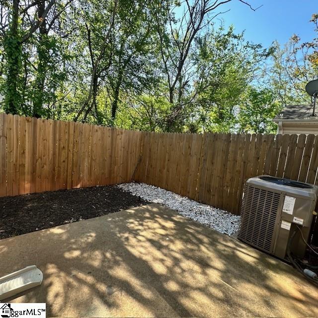 view of patio featuring central AC and fence