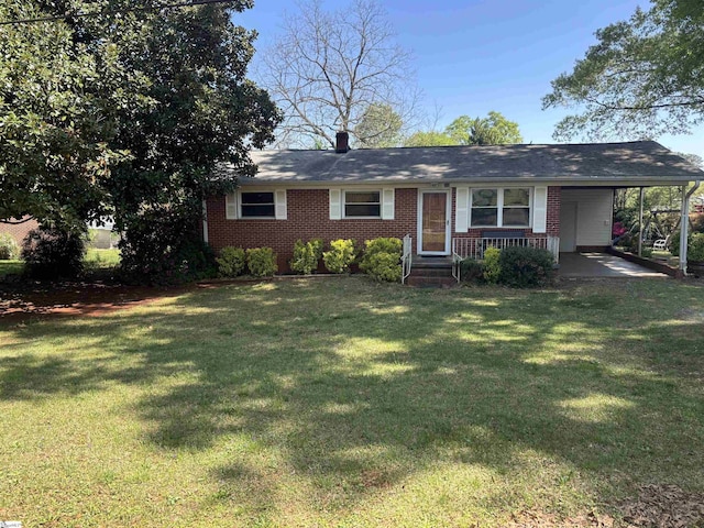 single story home featuring a front yard, an attached carport, and brick siding