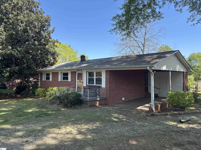single story home featuring brick siding, a front yard, a carport, and a chimney