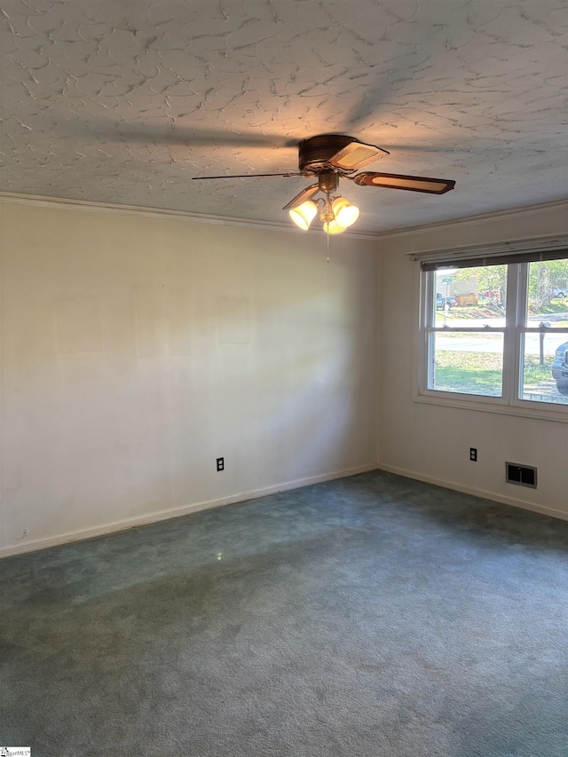 unfurnished room with visible vents, baseboards, a ceiling fan, and dark colored carpet