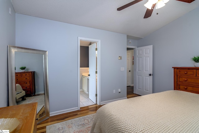 bedroom with wood finished floors, baseboards, and a ceiling fan