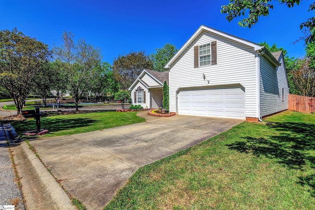 view of front facade with fence, a garage, a front yard, and concrete driveway