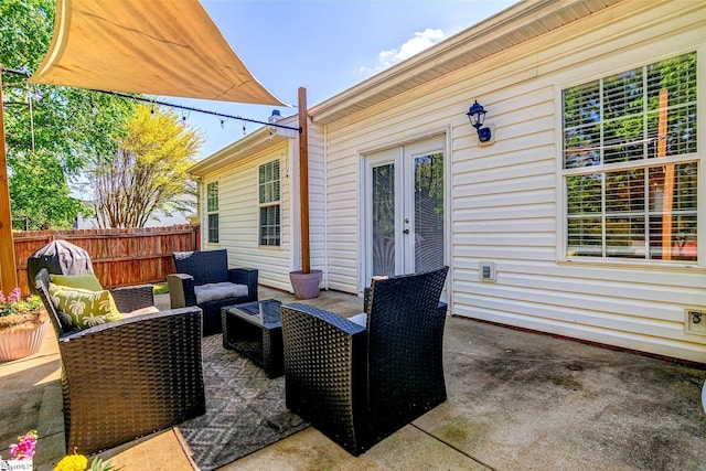 view of patio featuring french doors, an outdoor living space, and fence
