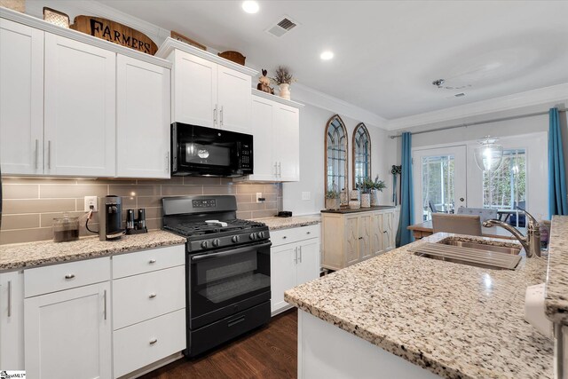 kitchen with visible vents, white cabinetry, black appliances, and ornamental molding