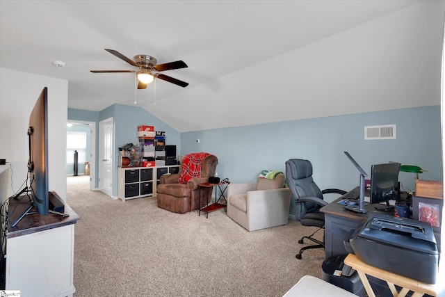 office space with visible vents, ceiling fan, carpet floors, and lofted ceiling