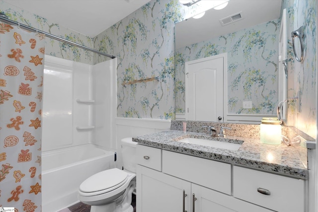 full bathroom with vanity, visible vents, toilet, wainscoting, and wallpapered walls