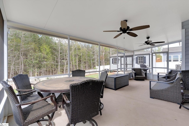 sunroom featuring outdoor dining space and a ceiling fan