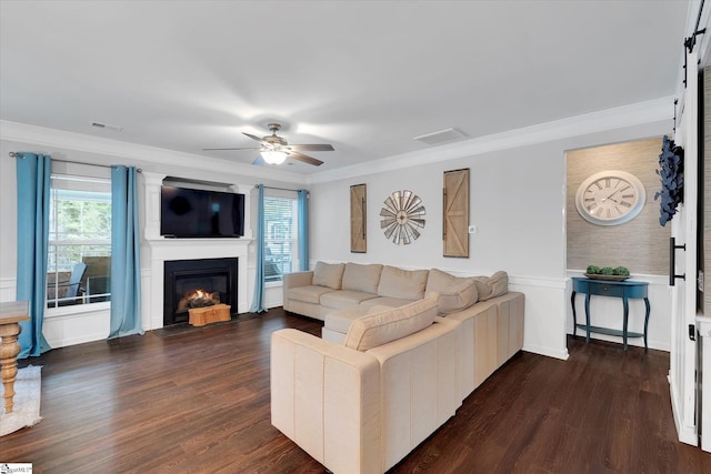 living room featuring a fireplace with flush hearth, crown molding, a healthy amount of sunlight, and visible vents