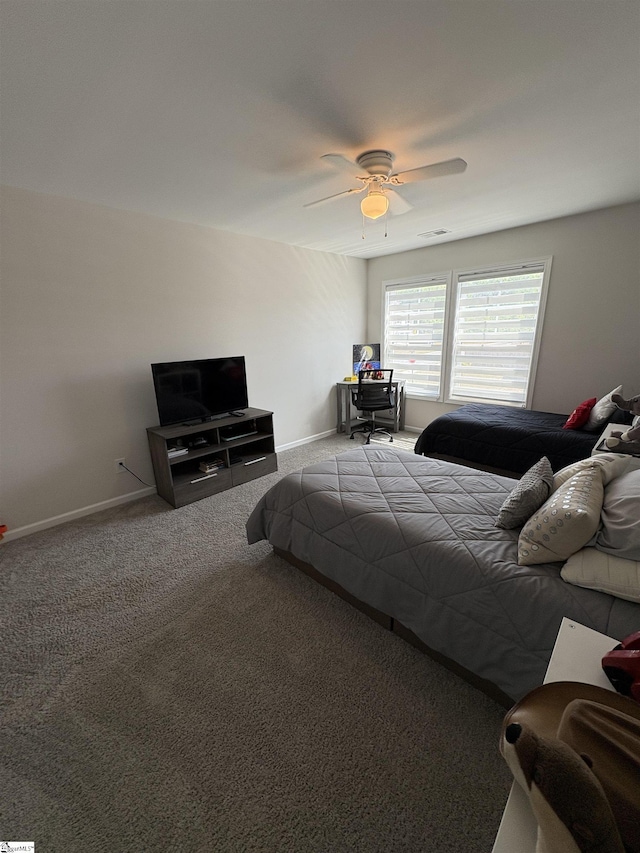 bedroom with a ceiling fan, baseboards, and carpet