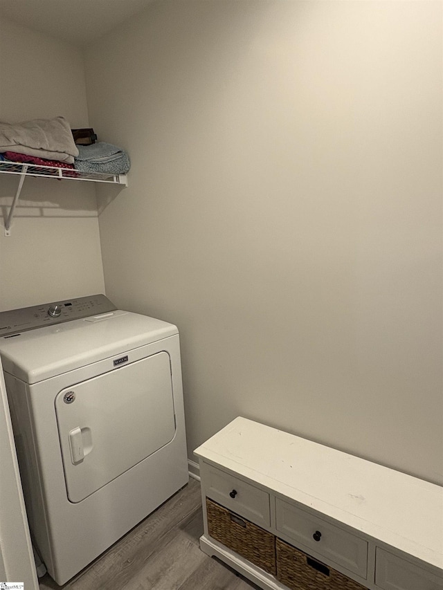 clothes washing area featuring washer / clothes dryer, laundry area, and light wood-type flooring