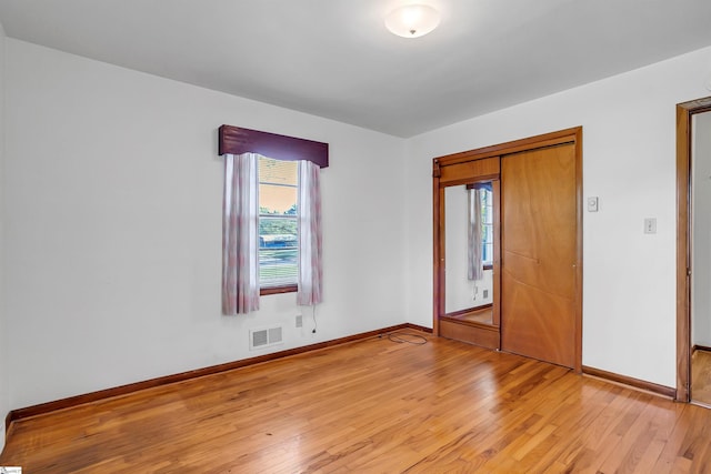 interior space featuring visible vents, baseboards, and light wood-style floors