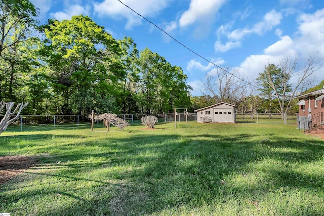 view of yard featuring an outbuilding and fence