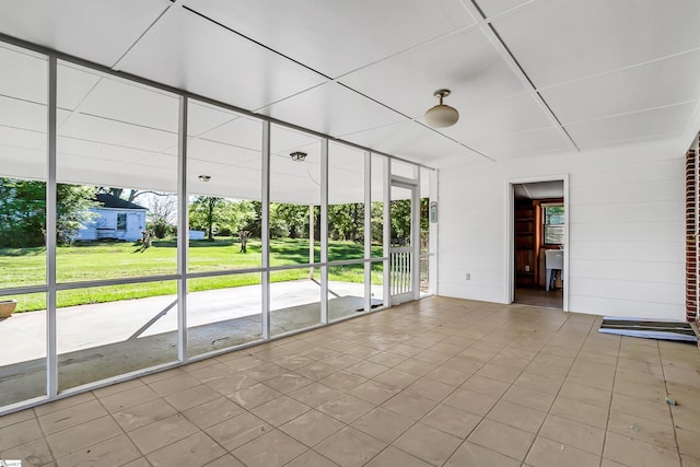 tiled spare room featuring expansive windows