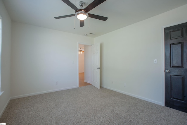 unfurnished bedroom with carpet, visible vents, baseboards, and a ceiling fan