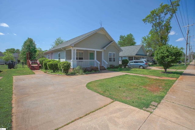 bungalow-style home featuring a front lawn, driveway, and a porch