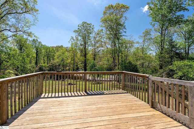 wooden deck with a lawn
