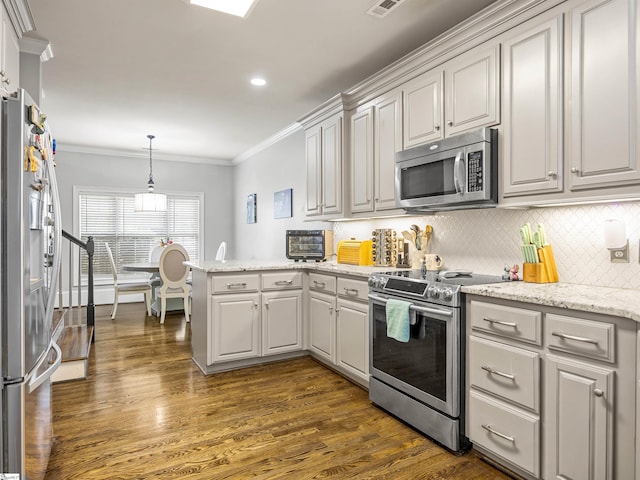 kitchen featuring a peninsula, dark wood-style flooring, ornamental molding, and appliances with stainless steel finishes