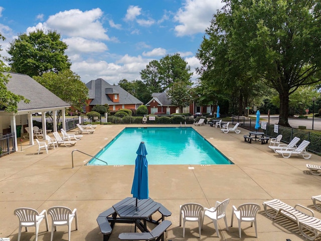 pool featuring a patio area and fence