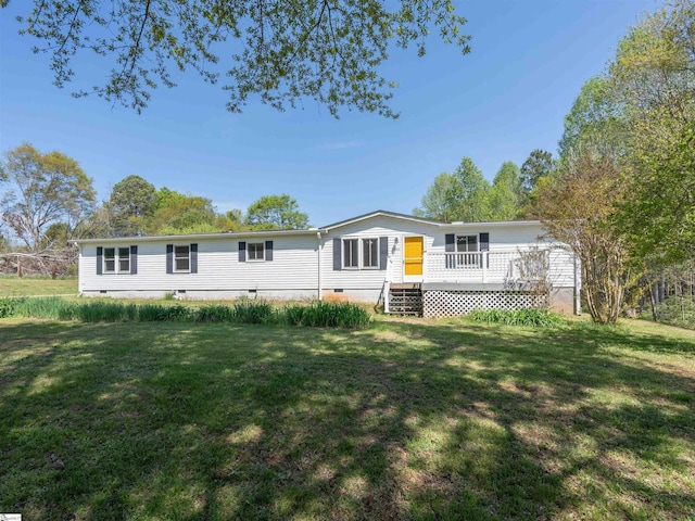 view of front facade with crawl space, a wooden deck, and a front lawn