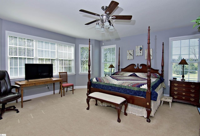 carpeted bedroom featuring baseboards and ceiling fan