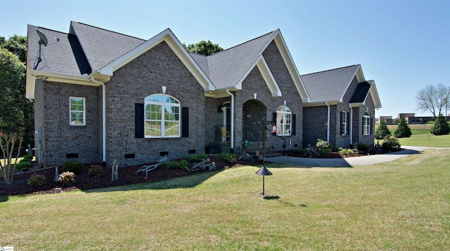 view of front of house with a shingled roof, crawl space, and a front lawn