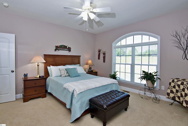 bedroom featuring visible vents, ceiling fan, light colored carpet, and baseboards