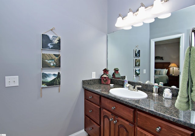 bathroom featuring ensuite bath and vanity