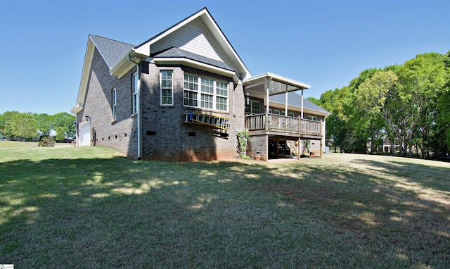 rear view of property featuring brick siding, a wooden deck, a lawn, and stairs