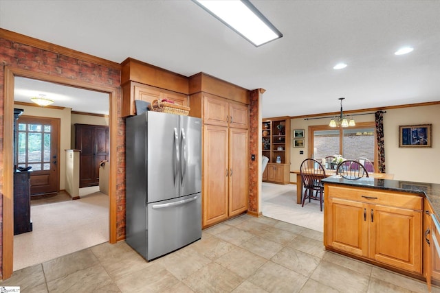 323 Long Reach Dr, Salem, SC 29676 - kitchen with hanging light fixtures, an inviting chandelier, ornamental molding, freestanding refrigerator, and light carpet