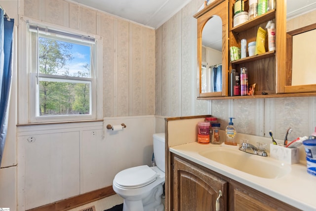 525 Firetower Rd, Williamston, SC 29697 - bathroom featuring plenty of natural light, toilet, vanity, wainscoting, and wallpapered walls